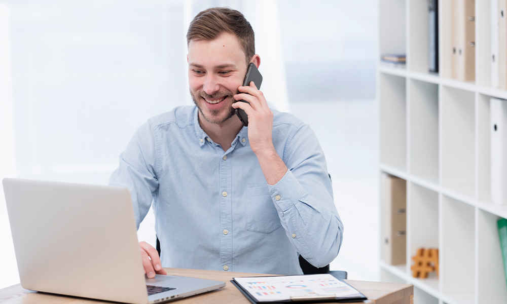 smiley man working laptop