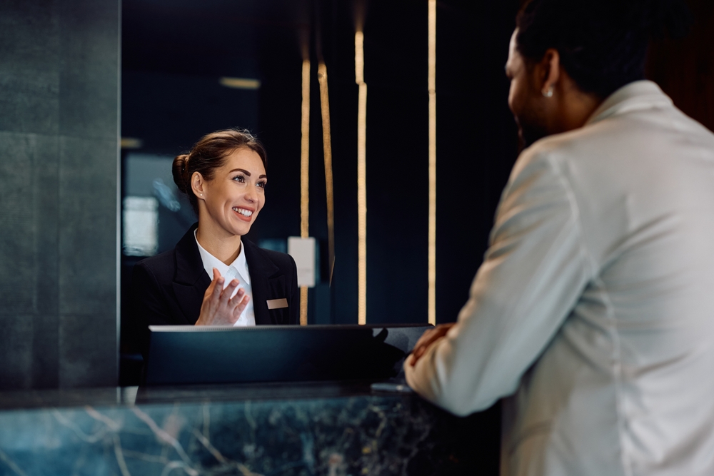 Happy,Female,Receptionist,Talking,To,African,American,Man,Who,Is